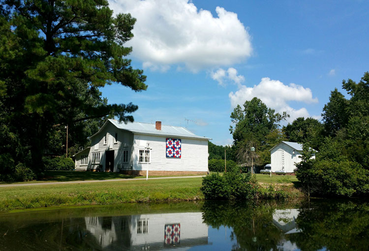 pond and barn with quilt block on side